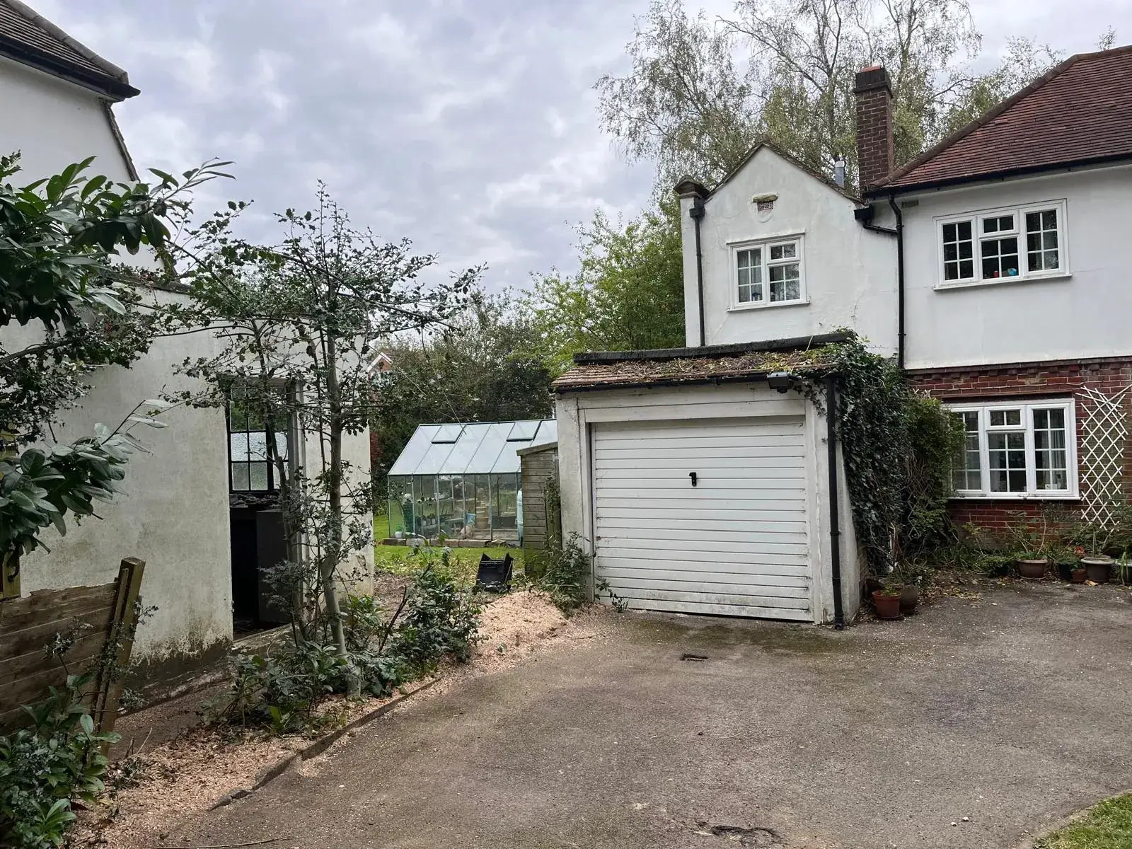 A side path and driveway cleared back to the garage