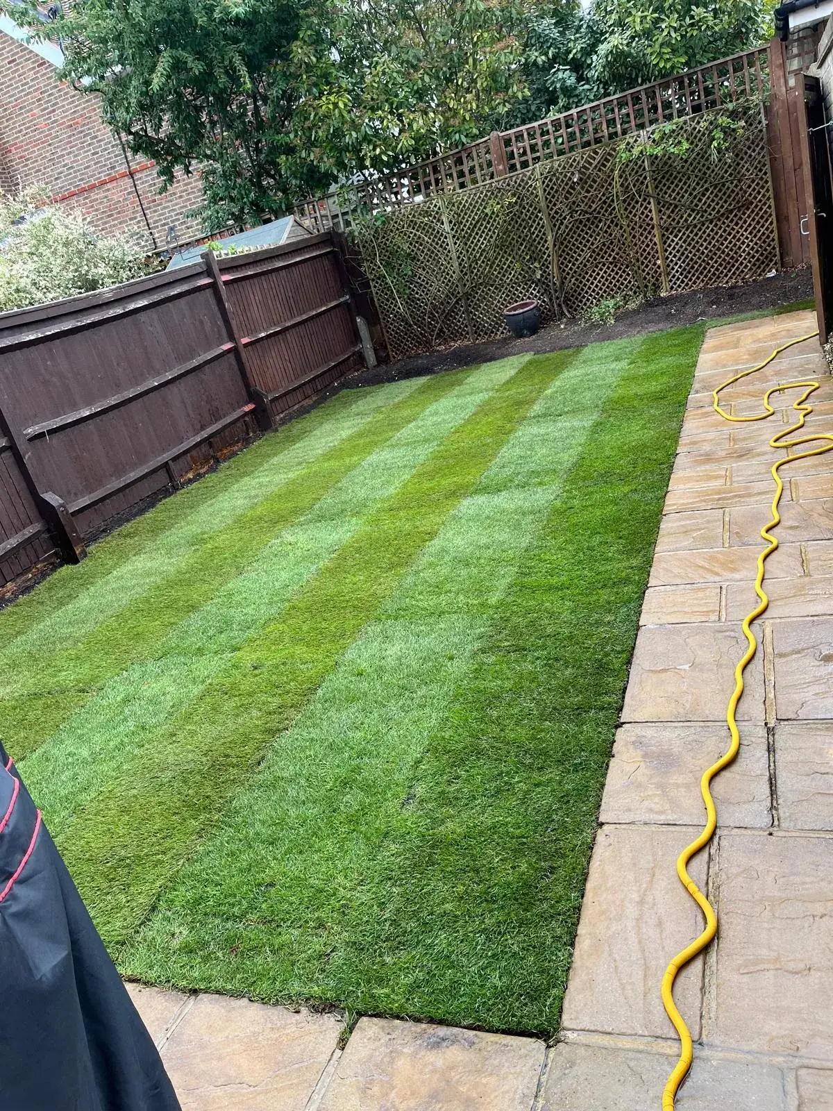 The same Smallfield garden with new turf laid and striped